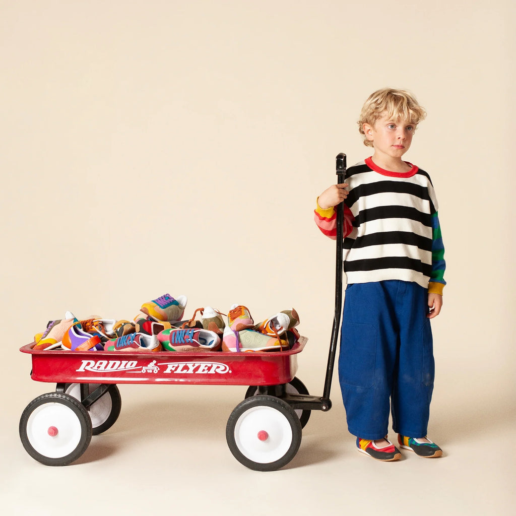 Kids workwear pants in blue, flat lay on a neutral background.